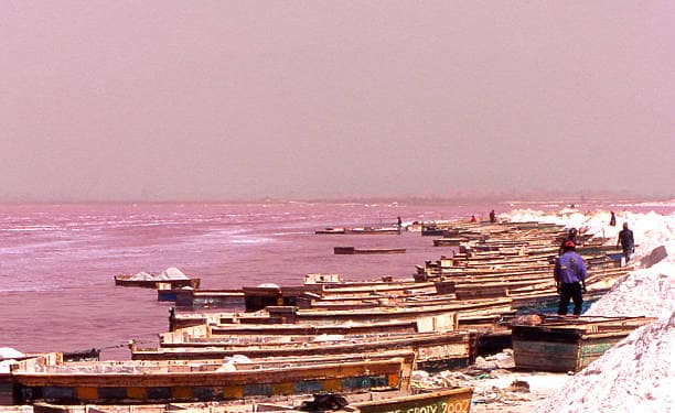 Salt heaped up into cones over the shore of a salty lake in Senegal